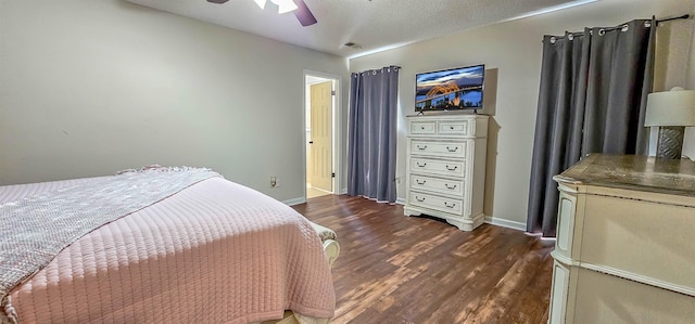 bedroom with ceiling fan, dark hardwood / wood-style flooring, and a textured ceiling