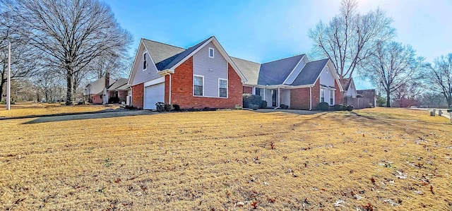 view of side of home with a lawn and a garage