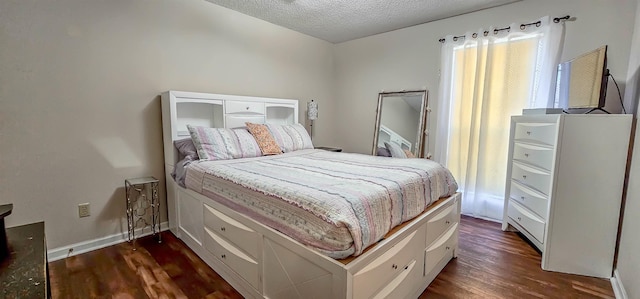 bedroom with dark hardwood / wood-style flooring and a textured ceiling