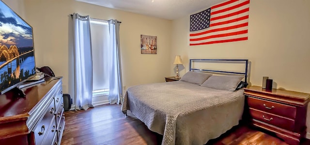 bedroom featuring dark hardwood / wood-style flooring