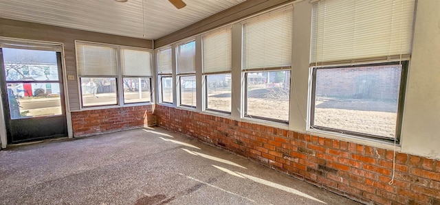 unfurnished sunroom with ceiling fan