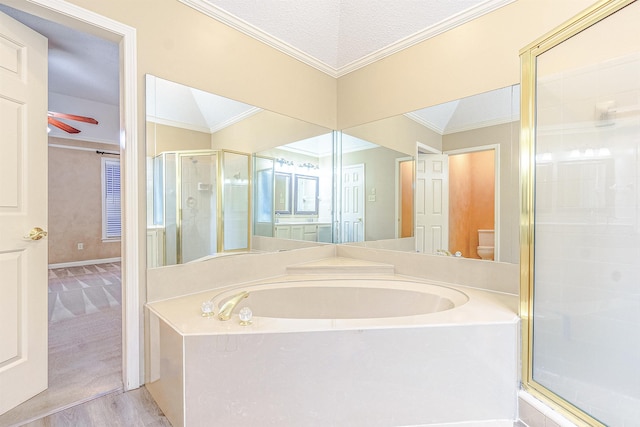 bathroom featuring shower with separate bathtub, toilet, and crown molding