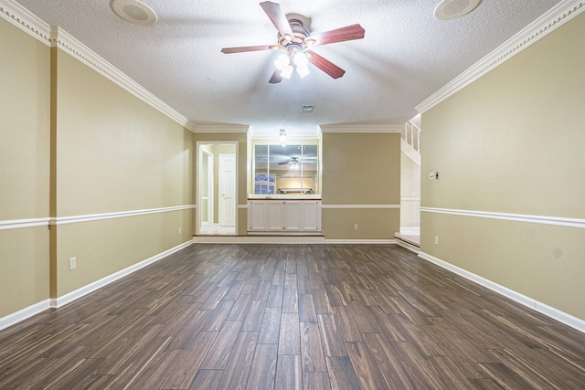 empty room with a textured ceiling, dark hardwood / wood-style flooring, and crown molding