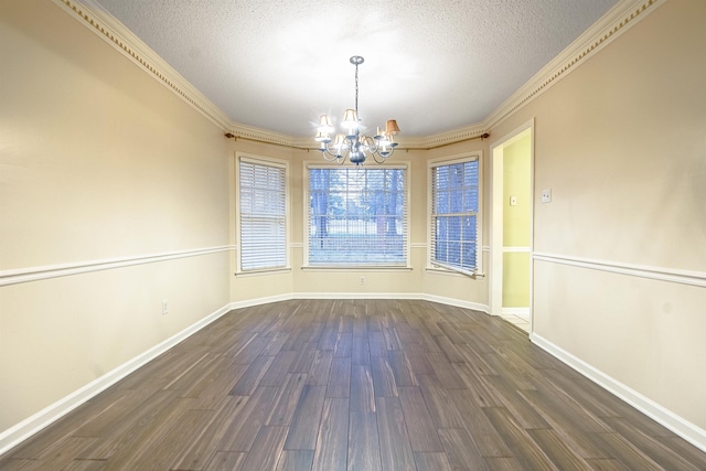 unfurnished dining area with dark hardwood / wood-style flooring, ornamental molding, a textured ceiling, and a chandelier