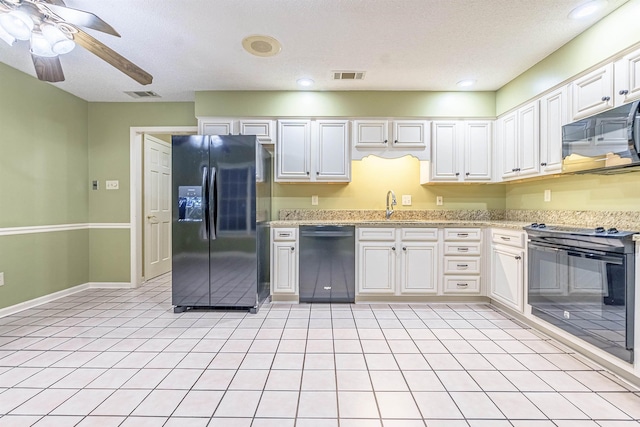 kitchen with white cabinetry, sink, ceiling fan, light tile patterned floors, and black appliances