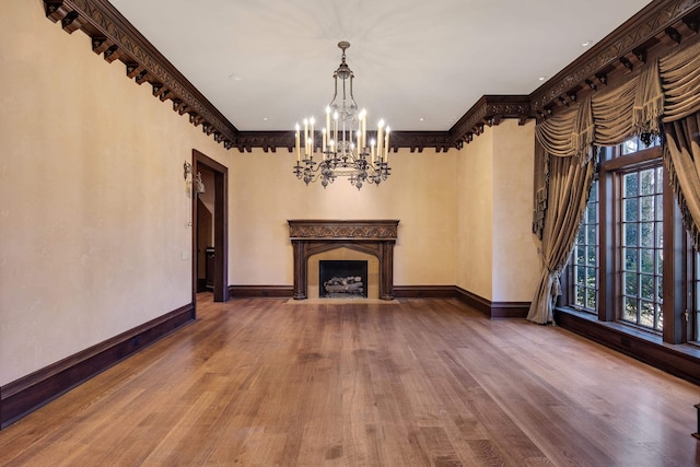 unfurnished living room featuring a fireplace, hardwood / wood-style floors, and ornamental molding