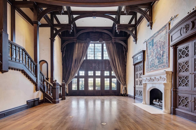 living room with hardwood / wood-style flooring and a high ceiling