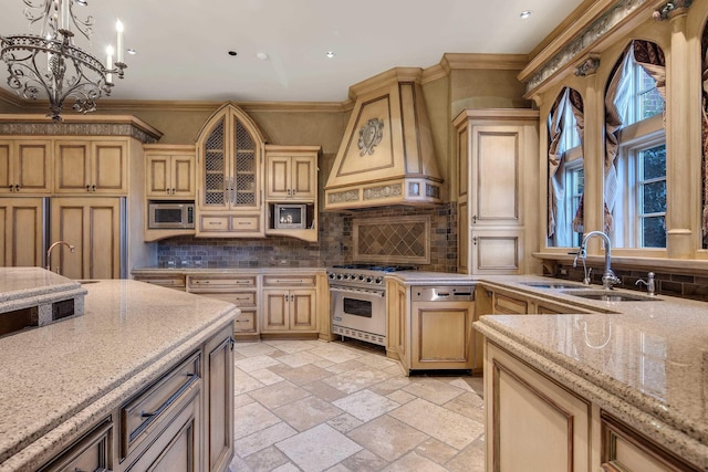 kitchen with appliances with stainless steel finishes, ornamental molding, custom exhaust hood, sink, and decorative light fixtures