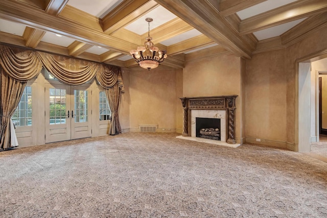 unfurnished living room featuring coffered ceiling, a high end fireplace, carpet floors, a chandelier, and ornamental molding