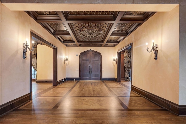 hallway featuring beam ceiling, ornamental molding, and coffered ceiling