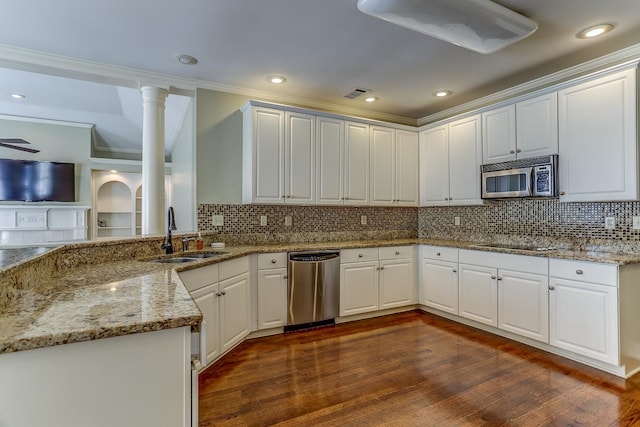 kitchen with white cabinetry, sink, light stone counters, dark hardwood / wood-style floors, and appliances with stainless steel finishes