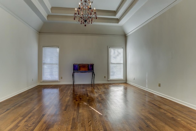 unfurnished living room with a notable chandelier, a raised ceiling, crown molding, and dark wood-type flooring