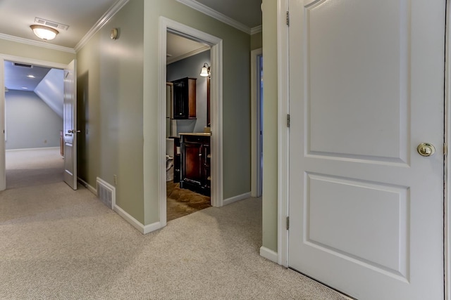 hall featuring carpet floors, crown molding, and vaulted ceiling