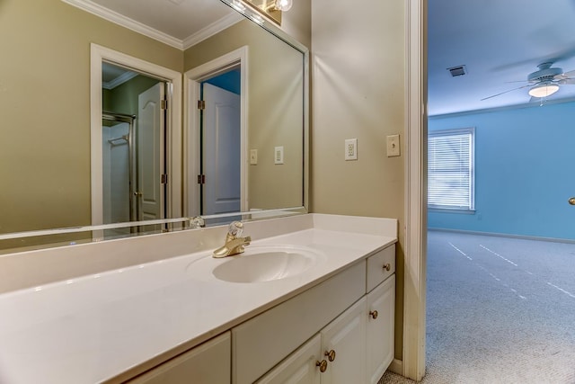 bathroom featuring an enclosed shower, vanity, ceiling fan, and ornamental molding