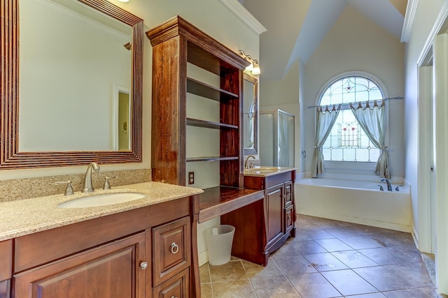 bathroom featuring tile patterned flooring, vanity, a tub to relax in, and crown molding