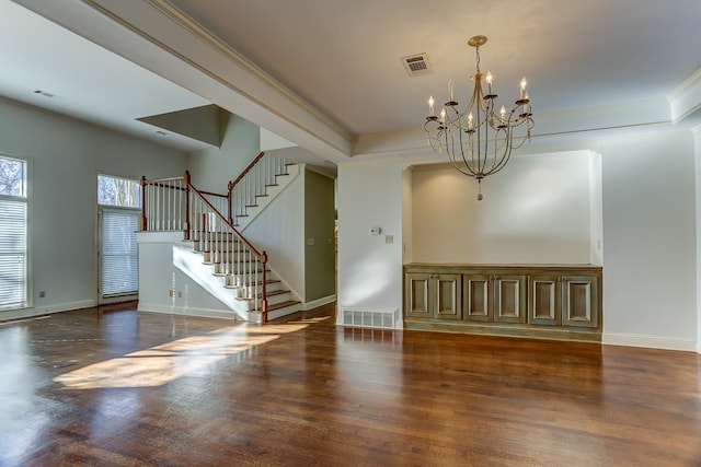 spare room featuring a notable chandelier and crown molding