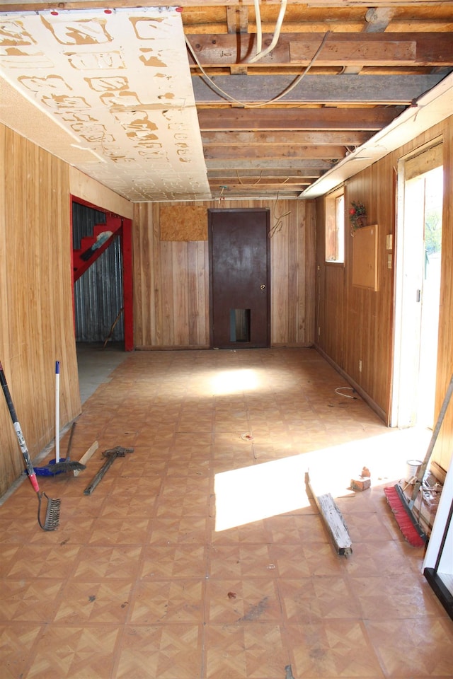 interior space with wood walls and parquet flooring