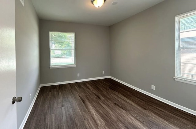 empty room with dark hardwood / wood-style floors