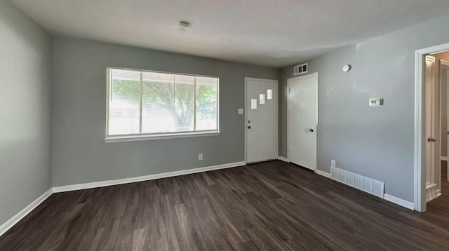 empty room featuring dark wood-type flooring