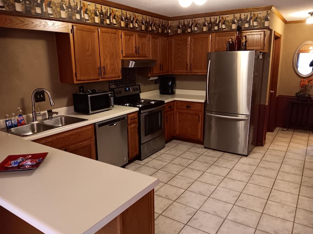 kitchen featuring light countertops, appliances with stainless steel finishes, and brown cabinets