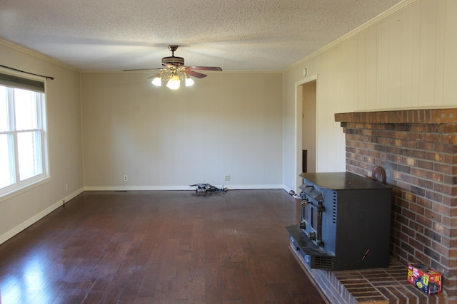 unfurnished living room featuring a textured ceiling, a wood stove, and ornamental molding