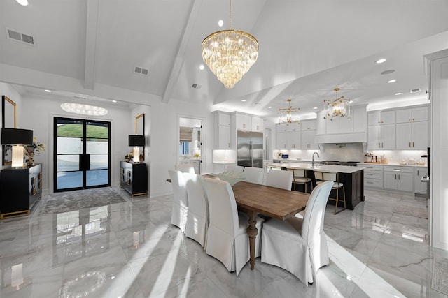 dining space featuring a chandelier, beam ceiling, high vaulted ceiling, and sink