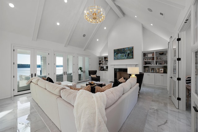 living room with built in shelves, french doors, high vaulted ceiling, a notable chandelier, and a water view