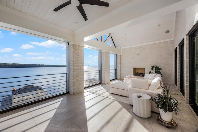 sunroom / solarium with a water view, vaulted ceiling, ceiling fan, and wood ceiling