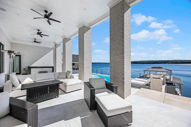 view of patio with an outdoor living space and a water view