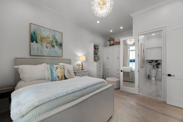 bedroom with light hardwood / wood-style floors, ornamental molding, connected bathroom, and an inviting chandelier