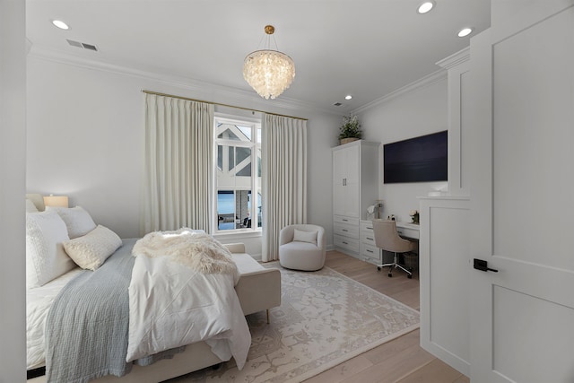 bedroom featuring light hardwood / wood-style floors, an inviting chandelier, and crown molding