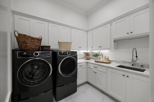 washroom with cabinets, independent washer and dryer, crown molding, and sink