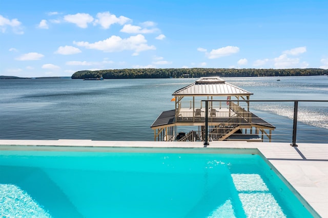 view of pool with a gazebo and a water view