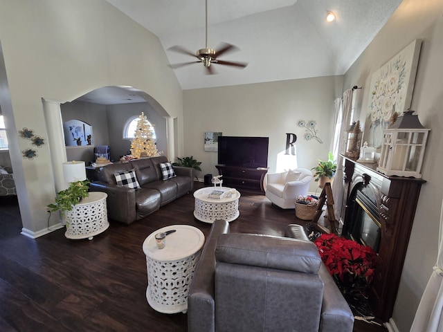 living room with dark hardwood / wood-style flooring, high vaulted ceiling, and ceiling fan