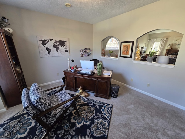 office area with carpet flooring and a textured ceiling