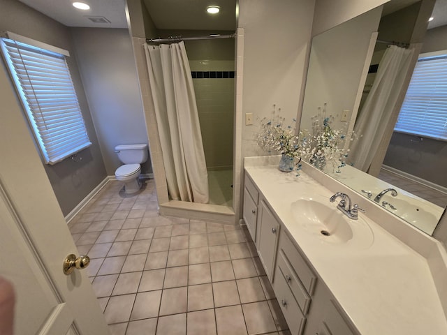 bathroom featuring toilet, vanity, tile patterned floors, and curtained shower