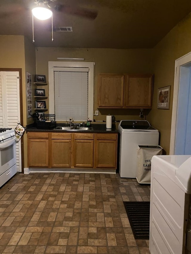 washroom featuring washer and clothes dryer and sink