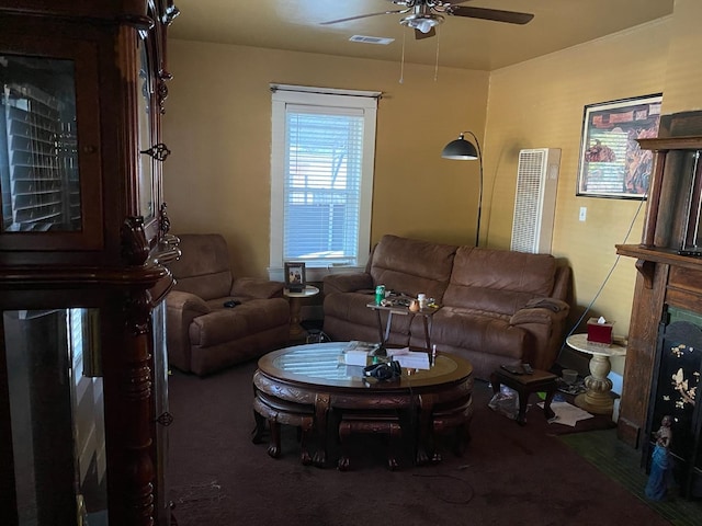 living room with ceiling fan and dark carpet