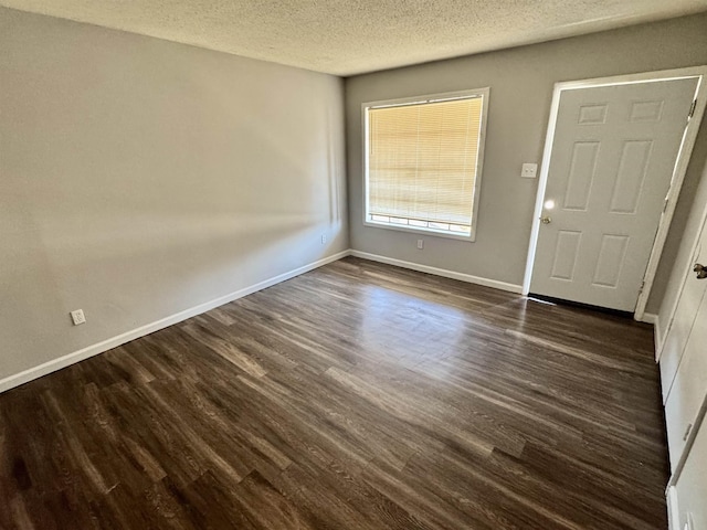 foyer with a textured ceiling and dark wood-type flooring