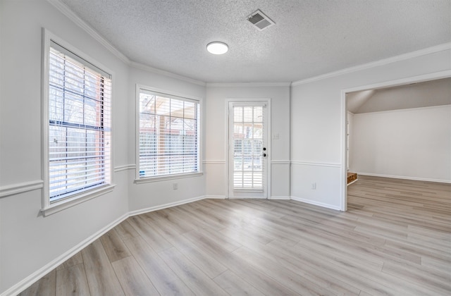 empty room with a textured ceiling, light hardwood / wood-style flooring, a wealth of natural light, and crown molding