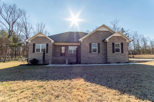 ranch-style home featuring a front yard