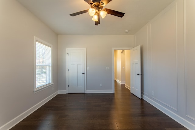 unfurnished bedroom featuring ceiling fan, a closet, and dark hardwood / wood-style floors