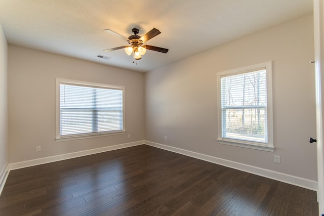 empty room with ceiling fan and dark hardwood / wood-style floors