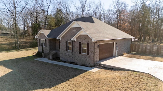 view of front of property featuring a garage and a front lawn