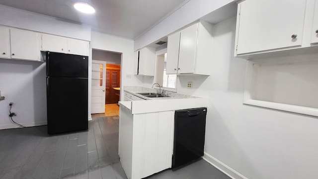 kitchen featuring black appliances, light countertops, a sink, and white cabinetry