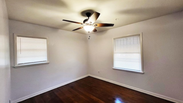 empty room with ceiling fan, baseboards, and dark wood-type flooring