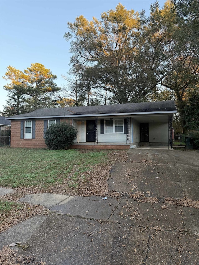 view of front of property with a front yard and a carport