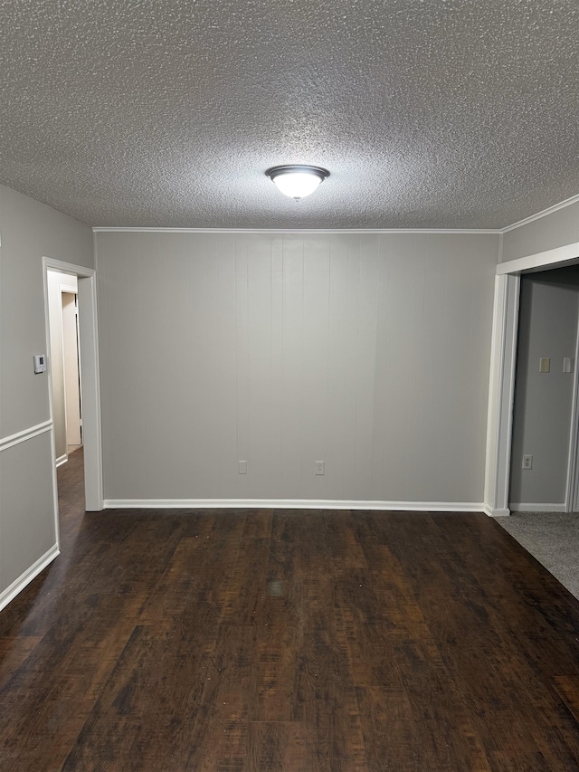 unfurnished room with a textured ceiling and dark hardwood / wood-style flooring