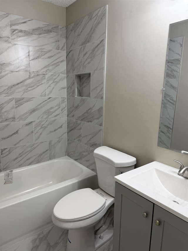 full bathroom featuring toilet, tiled shower / bath, and vanity