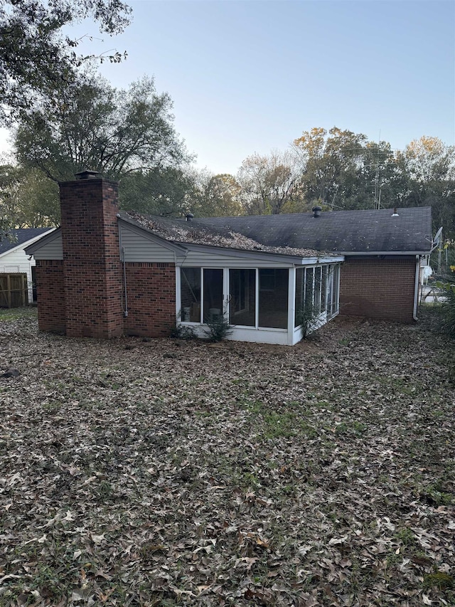 rear view of property with a sunroom